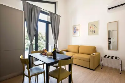 a living room with a table and a couch at Urban Oasis near Termini with Patio, int1b in Rome
