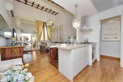 a kitchen with a white island in a room at Luxury Navona apartments by Flatinrome in Rome