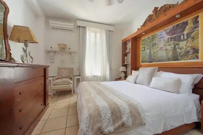 a bedroom with a large bed and a dresser at Luxury Navona apartments by Flatinrome in Rome
