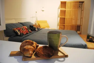 a tray with a cup and two croissants on a table at Alloggio Appio Claudio con Corte Esclusiva I Metro A in Rome