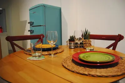 a wooden table with plates and wine glasses on it at Alloggio Appio Claudio con Corte Esclusiva I Metro A in Rome