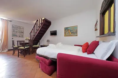 a bedroom with a king sized bed and a staircase at St.Margherita Charming House in Rome