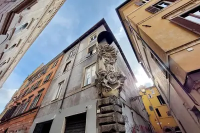 a building with a statue on the side of it at St.Margherita Charming House in Rome