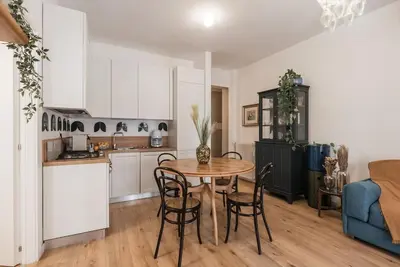 a kitchen and dining room with a table and chairs at Vatican Elegance House in Rome