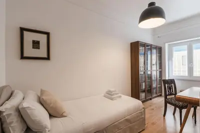 a bedroom with a couch and a table and a desk at Vatican Elegance House in Rome