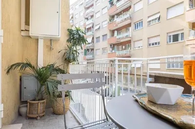 a balcony with a table and a glass of beer at Vatican Elegance House in Rome