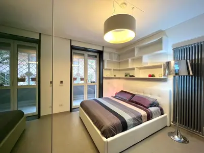 a bedroom with a bed and a glass wall at Apuania 12 in Rome