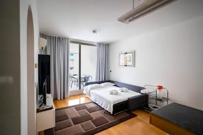 a bedroom with a bed and a television in it at 5 Min From Trastevere Rome Chic Apartment in Rome