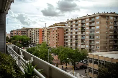 a view of a city with tall buildings at 5 Min From Trastevere Rome Chic Apartment in Rome