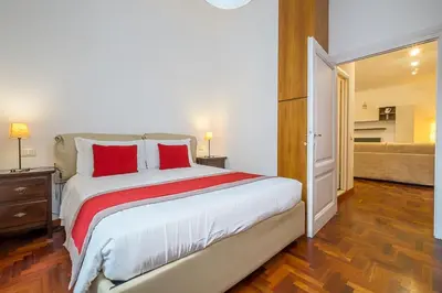 a bedroom with a large bed with red pillows at ht m&n bilo colosseo in Rome