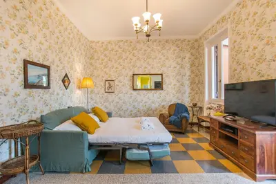 a living room with a couch and a flat screen tv at Casa di Alice in Rome