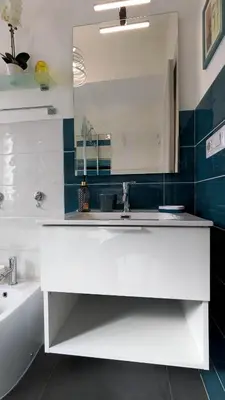 a white bathroom with a sink and a mirror at Nuova Casa Elena a Montesacro in Rome