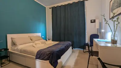 a bedroom with a bed and a blue wall at Nuova Casa Elena a Montesacro in Rome