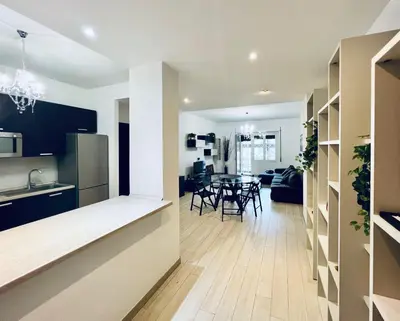 a kitchen and living room with a table and chairs at home sweet home san pietro in Rome