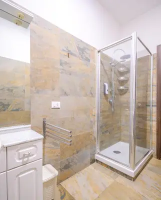 a shower with a glass door in a bathroom at home sweet home san pietro in Rome