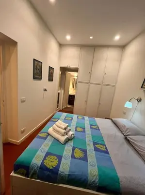 a bedroom with a bed with towels on it at Colosseum Apartment - Your Cozy Roman Escape in Rome