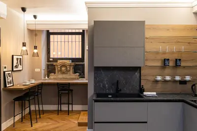 a kitchen with a counter and a bar with stools at Amazing 3-Bedrooms Pantheon in Rome