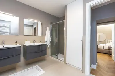 a bathroom with two sinks and a shower at Amazing 3-Bedrooms Pantheon in Rome