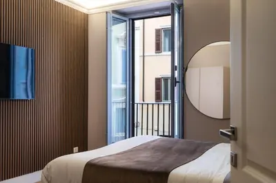 a bedroom with a bed and a mirror at Amazing 3-Bedrooms Pantheon in Rome