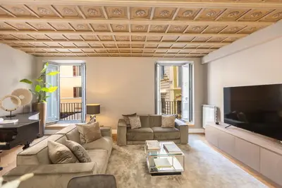 a living room with a couch and a flat screen tv at Amazing 3-Bedrooms Pantheon in Rome