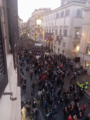 a large crowd of people walking down a city street at Exclusive apartments piazza di spagna 32 in Rome