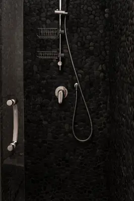 a bathroom with a shower with a stone wall at Exclusive apartments piazza di spagna 32 in Rome
