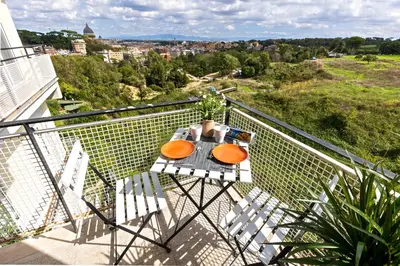 a table and two chairs on a balcony at Una Terrazza su San Pietro in Rome
