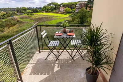 a balcony with a table and two chairs on it at Una Terrazza su San Pietro in Rome