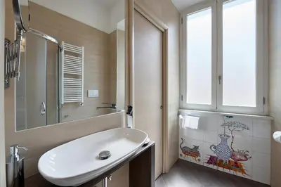 a bathroom with a white sink and a window at A casa di Roberta in Rome