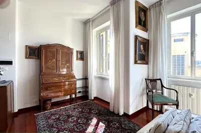 a bedroom with a dresser and a bed and a chair at Penthouse with terrace - Vatican Museums, Saint Peter's in Rome