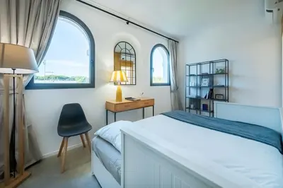 a bedroom with a bed and a desk and a chair at Della Vittoria Penthouse in Rome
