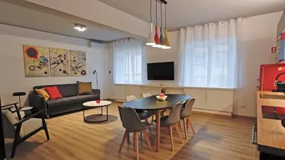 a living room with a table and a couch at RomeBestHome Scialoja - Piazza del Popolo in Rome