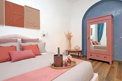 a bedroom with a large bed and a mirror at Romance al Colosseo 3 in Rome