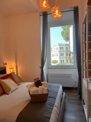 a bedroom with a bed and a large window at Romance al Colosseo 3 in Rome