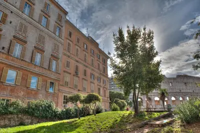 a large brick building with a tree in front of it at Romance al Colosseo 3 in Rome