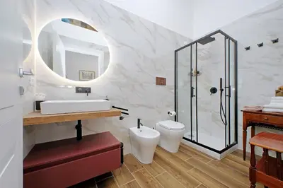 a bathroom with a sink and a toilet and a shower at Romance al Colosseo 3 in Rome