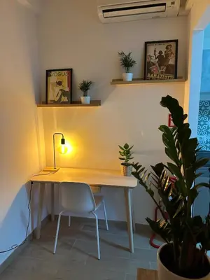 a desk with a lamp and a chair in a room at Alloggio turistico Gloria e Luigi in Rome