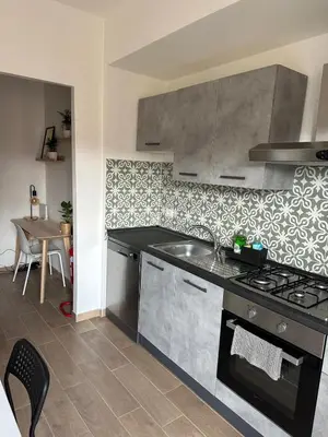 a kitchen with a sink and a stove top oven at Alloggio turistico Gloria e Luigi in Rome