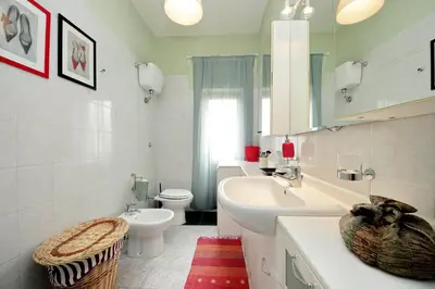 a white bathroom with a sink and a toilet at Rome Family Comfort Hub in Rome