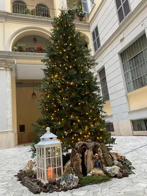 a christmas tree in front of a building with a lantern at A due passi dal Colosseo in Rome