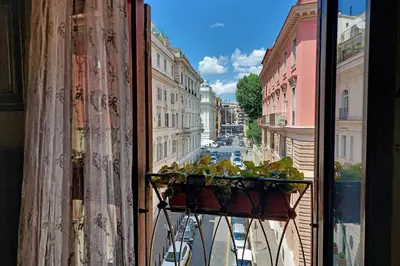 a window with a basket of plants on a balcony at Classic roman home next to Popolo Square in Rome