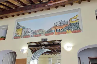 a painting on the wall of a building with an arch at Classic roman home next to Popolo Square in Rome