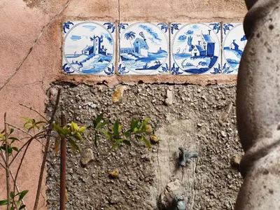 a blue and white plate on a wall at Vatican Treasure Garden in Rome