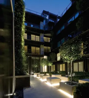 a building with a courtyard with trees and lights at Domus Urbana 152 in Rome
