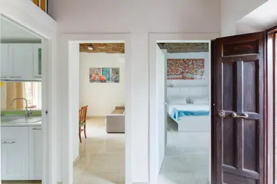 a kitchen and living room with a door leading to a bedroom at Villa Agostina in Rome
