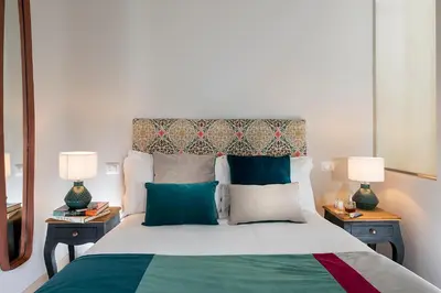 a bedroom with a large bed with two night stands at Boutique Hotel Atelier '800 in Rome