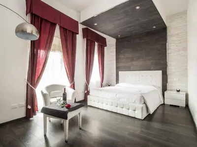a bedroom with a white bed and red curtains at Royal Rooms in Rome