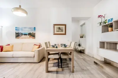 a living room with a white couch and a table at Roma Vatican Suites Inn in Rome
