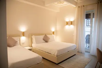 a bedroom with two beds and a window at Roxy luxury house Rome in Rome