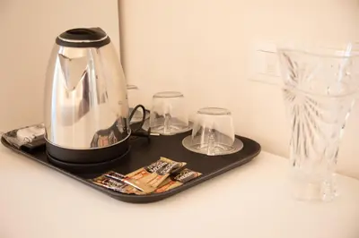 a tray with a tea kettle and glasses on a counter at Roxy luxury house Rome in Rome